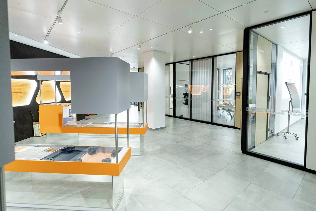 Korridor med m&ouml;tesrum bakom glasfront i Schl&uuml;ter-Systems kontorsbyggnad