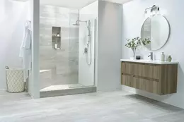 Salle de bain carrel&eacute;e de marbre gris avec douche et plan vasque