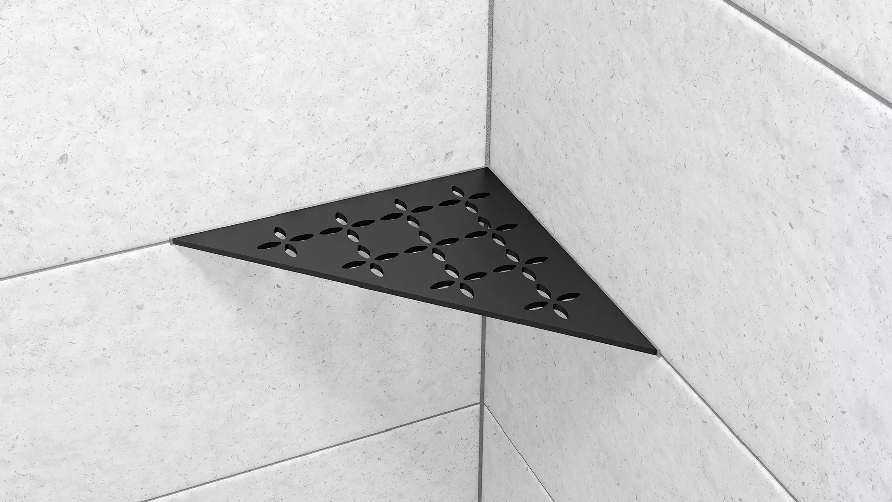 Vue d'une tablette d'angle Schl&uuml;ter-SHELF-E-S1 de forme triangulaire avec design FLORAL et finition MGS, noir graphite mat, mise en œuvre sur un carrelage mural gris clair.