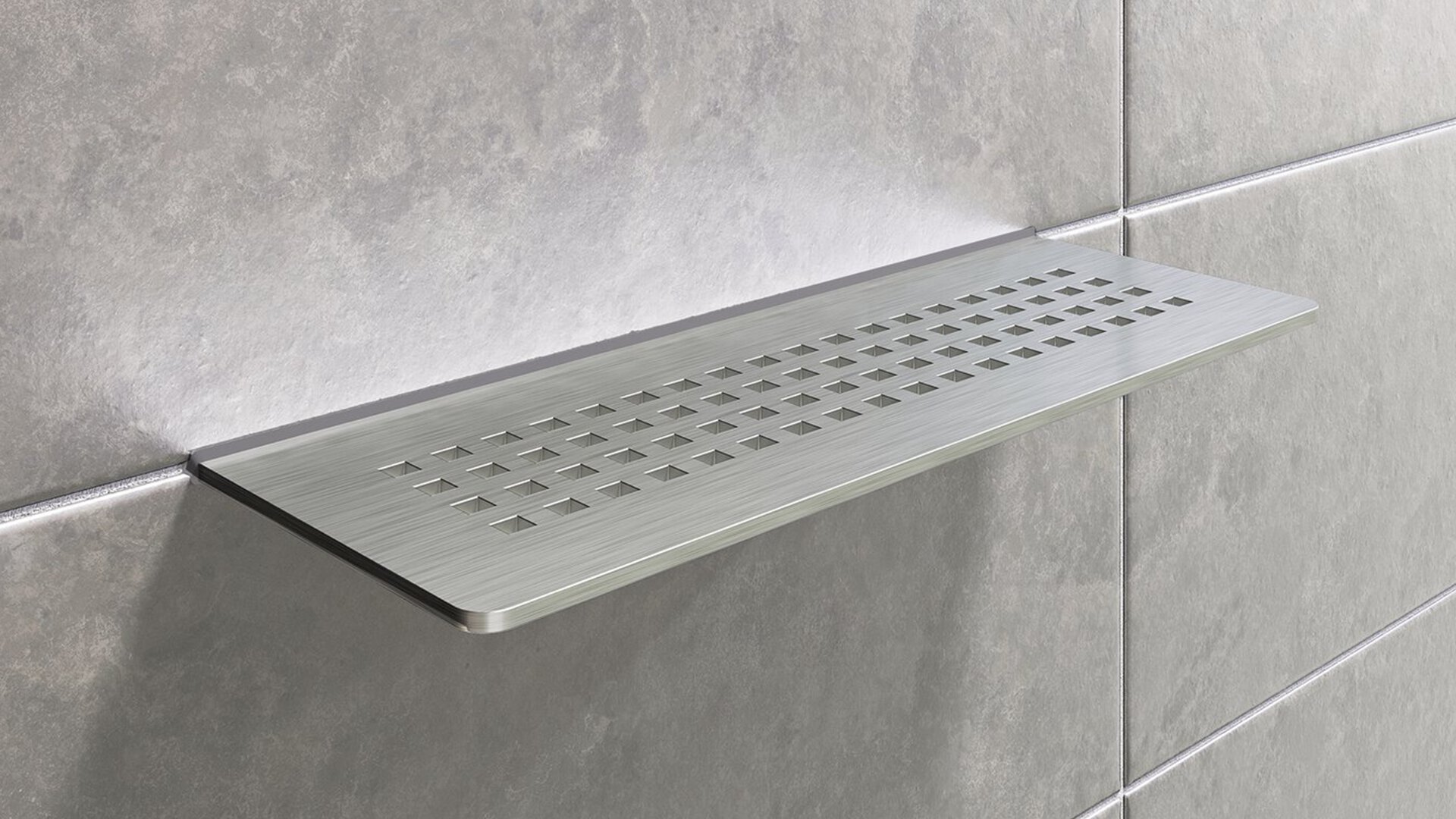 Wall-mounted Schluter shower shelf for integrated storage in modern tiled showers.