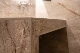 Primer plano de una esquina de un lavabo alicatado en combinaci&oacute;n con perfiles de remate en acabado TRENDLINE