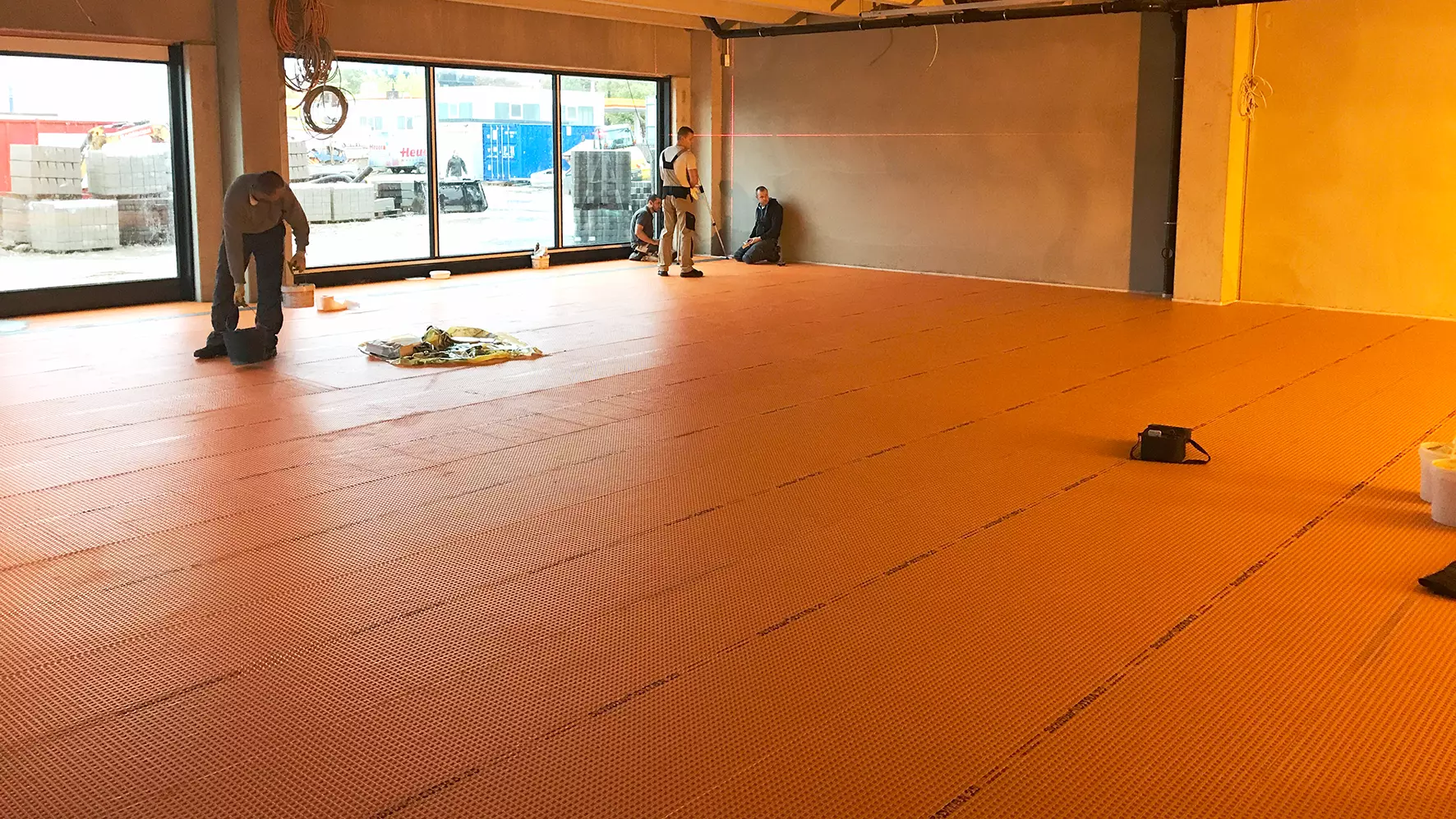 Tegelzetters beginnen met het leggen op Schl&uuml;ter-DITRA 25