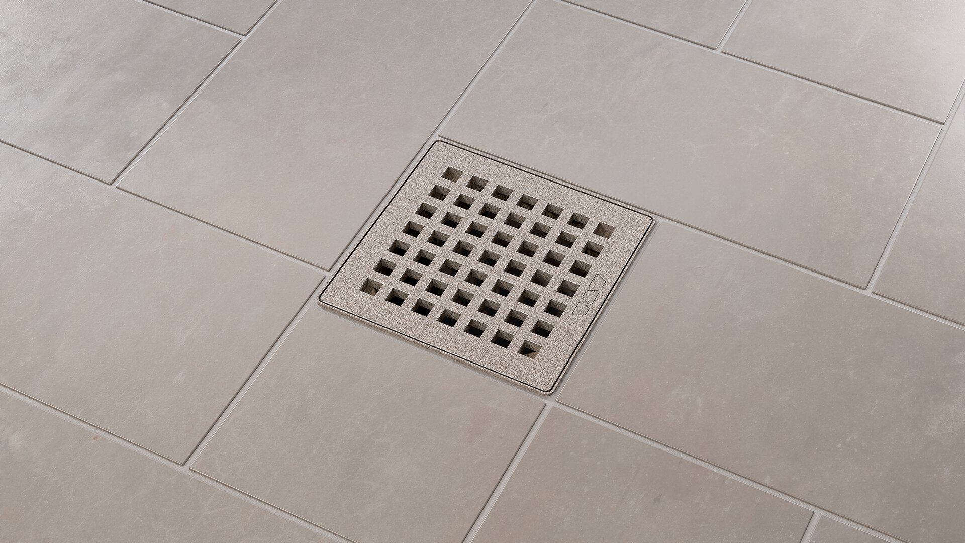 Schluter KERDI-DRAIN point drain with brushed stainless steel square grate installed in a tiled shower floor