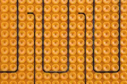 Orangene DITRA-HEAT Entkopplunsmatte mit einem darauf verlegten schwarzen Heizkabel
