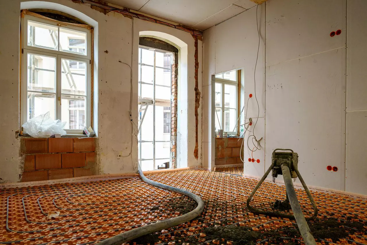 Een te renoveren ruimte in een oud gebouw wordt aangelegd met het BEKOTEC-THERM vloerverwarmingssysteem, waarop een zeer vlakke dekvloer wordt gestort