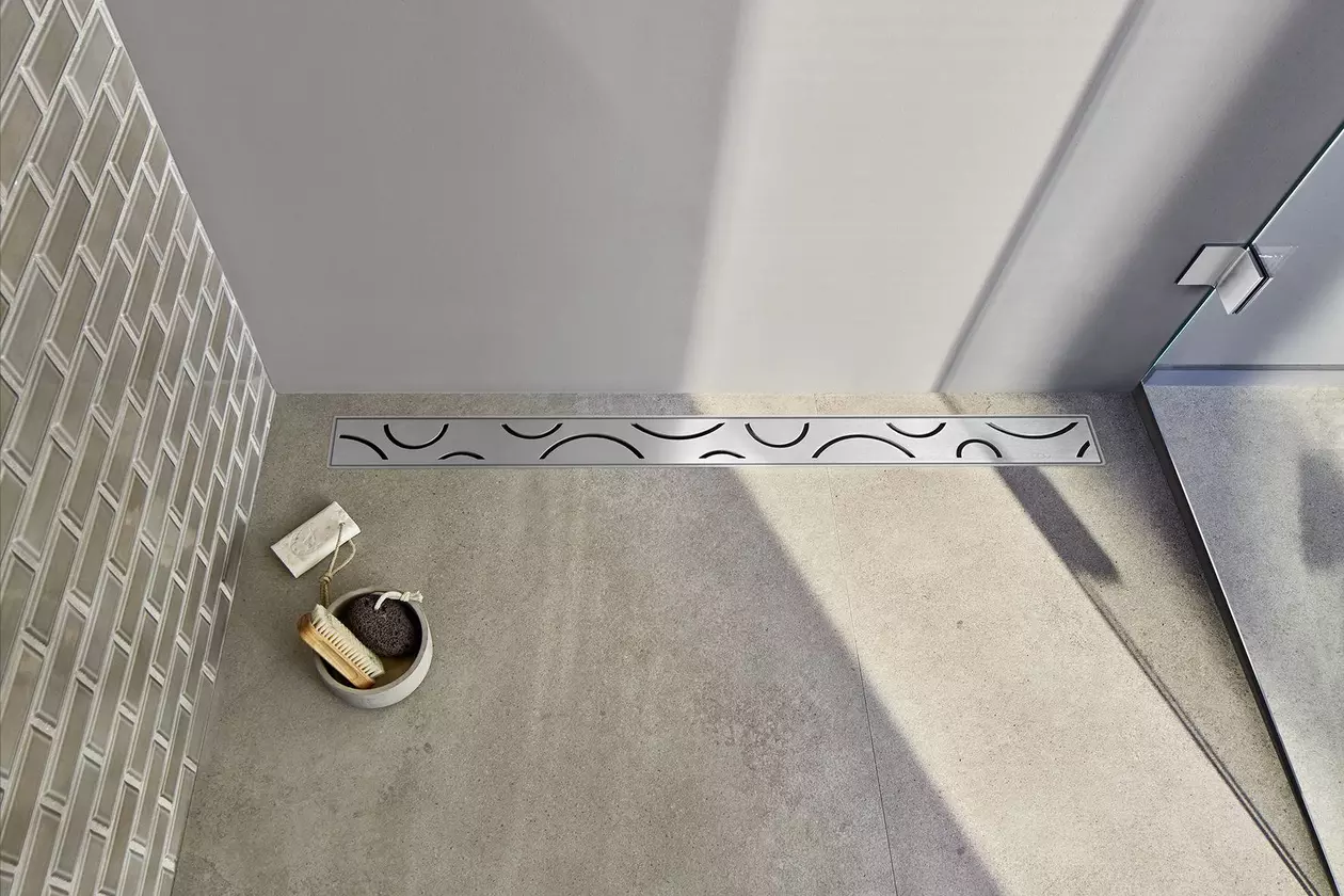 Birdseye view of patterned stainless steel wetroom shower drain