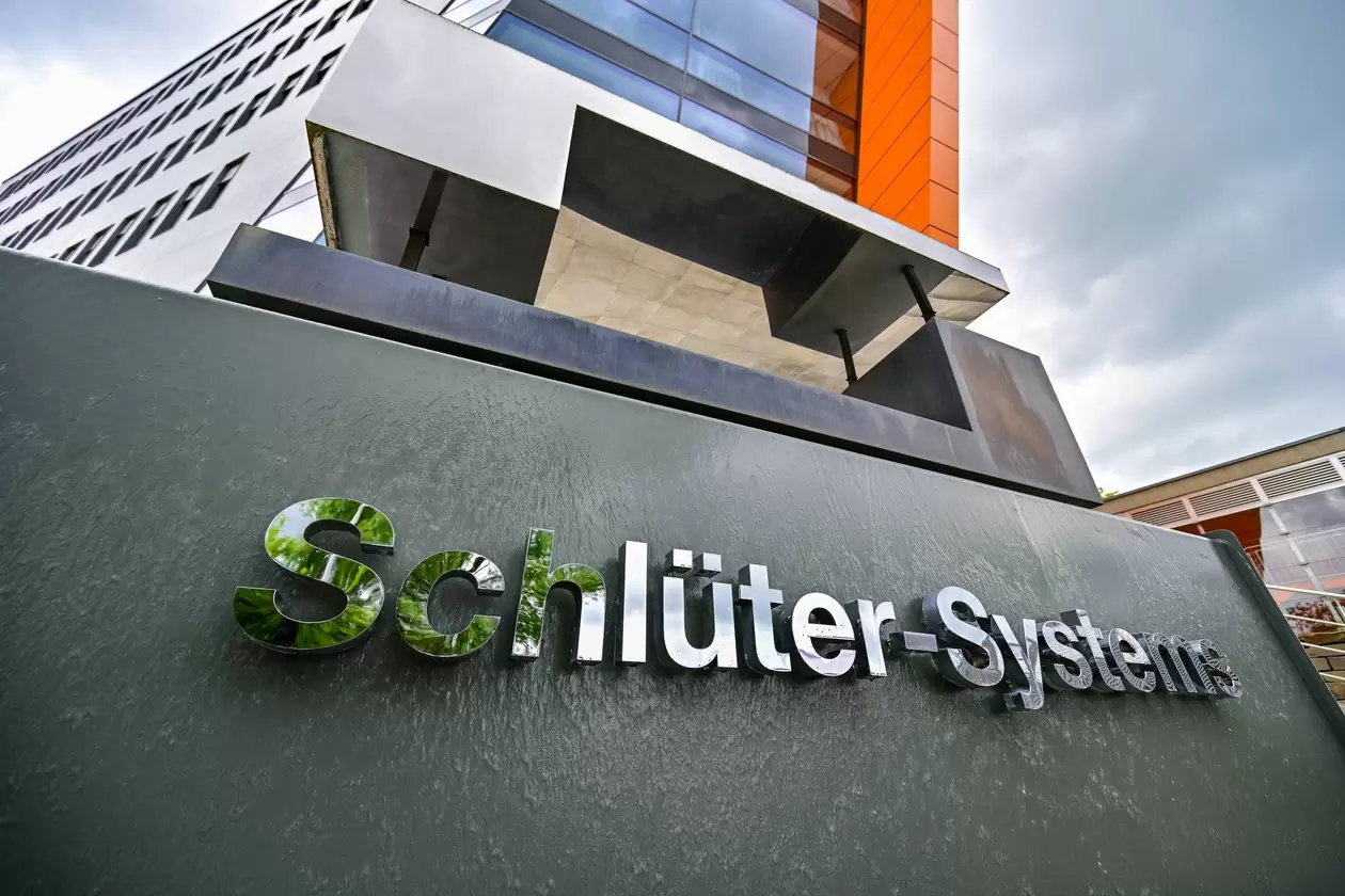 Schriftzug "Schl&uuml;ter-Systems" steht unter einer Skulptur des Firmen-Logos vor der Unternehmenszentrale