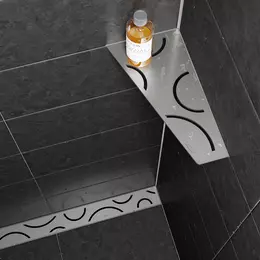 Estante de ducha Schl&uuml;ter-SHELF-E y desag&uuml;e lineal Schl&uuml;ter-KERDI-LINE en dise&ntilde;o FLORAL de acero inoxidable cepillado