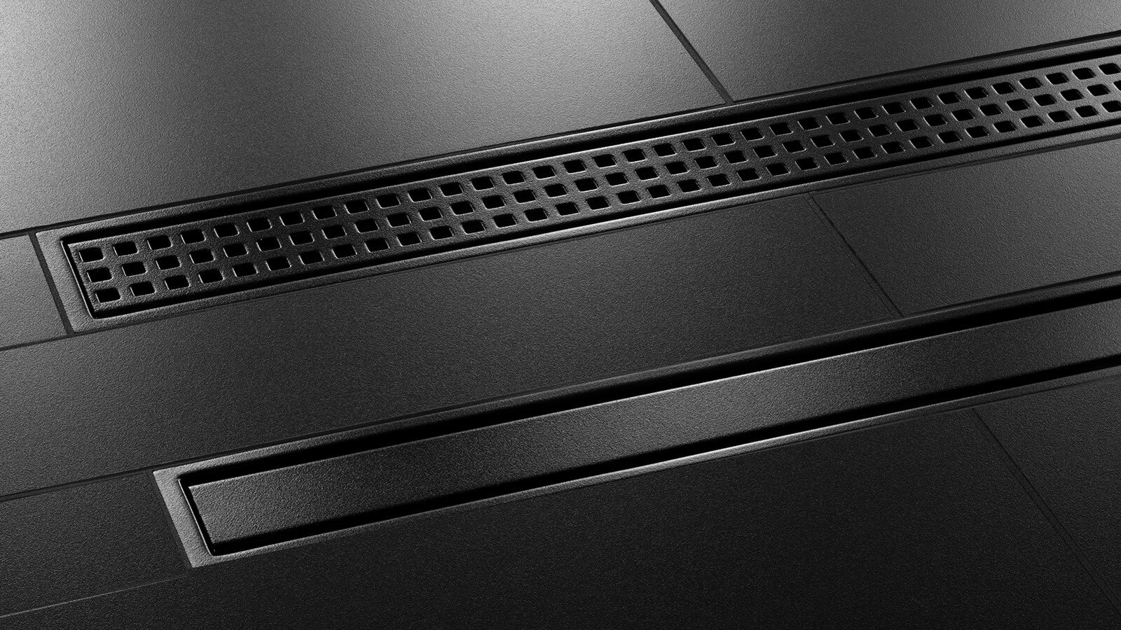 Matte black Schluter linear shower drain for modern tiled shower designs.