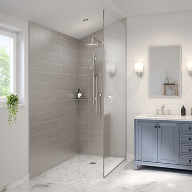 Image d'aperçu du blogue Espaces inclusifs : Créer une salle de bain sans obstacle pour votre maison présentant une douche et un lavabo modernes sans seuil